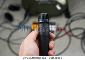 stock-photo-man-holding-microphone-in-recording-studio-361668086